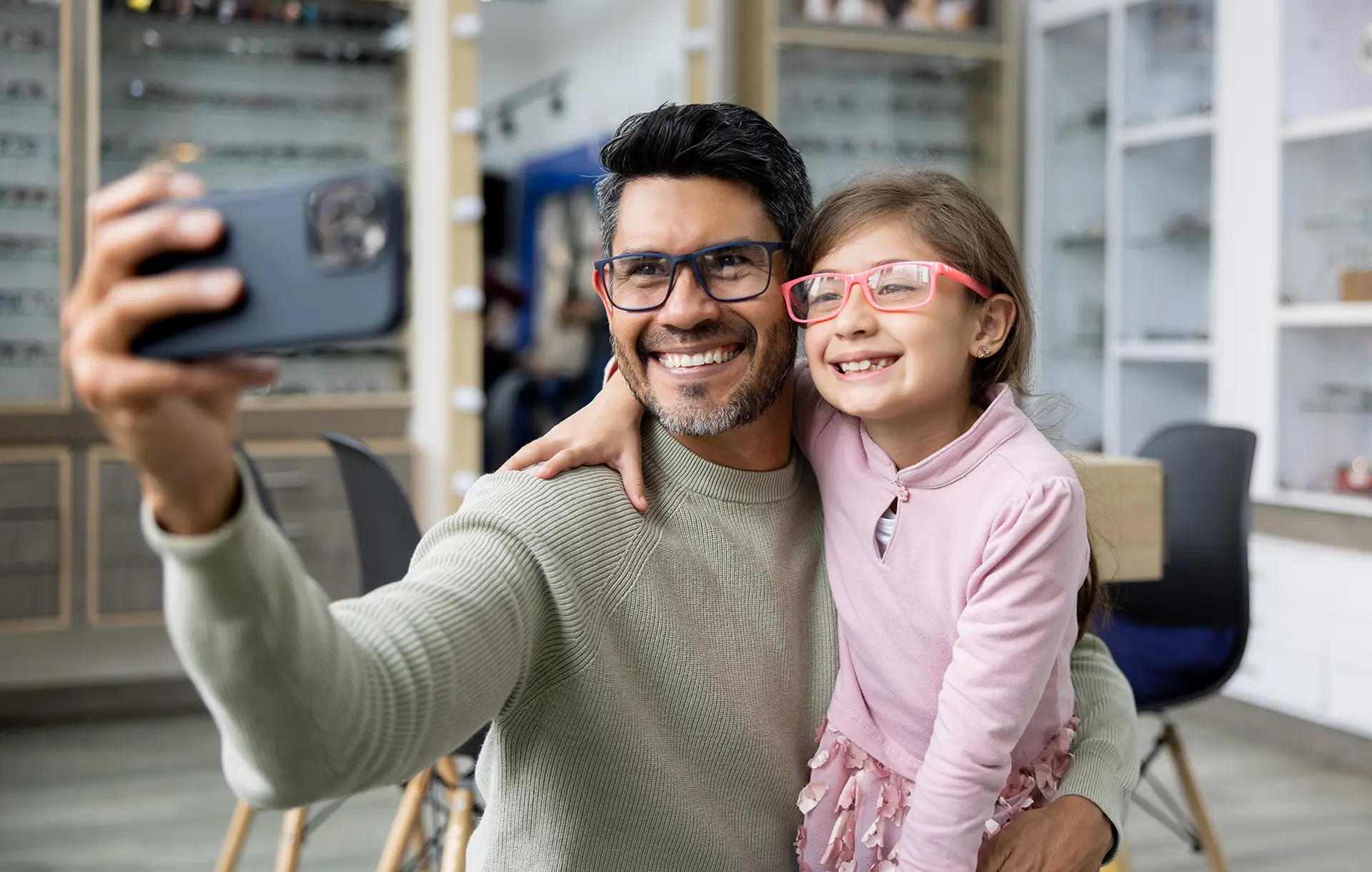 Dad and daughter, both wearing glasses and taking a selfie.