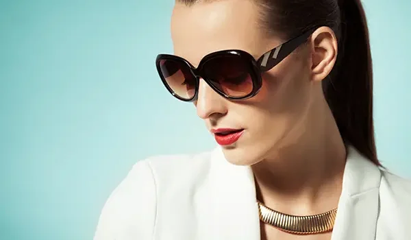 Well dressed woman wearing designer sunglasses.